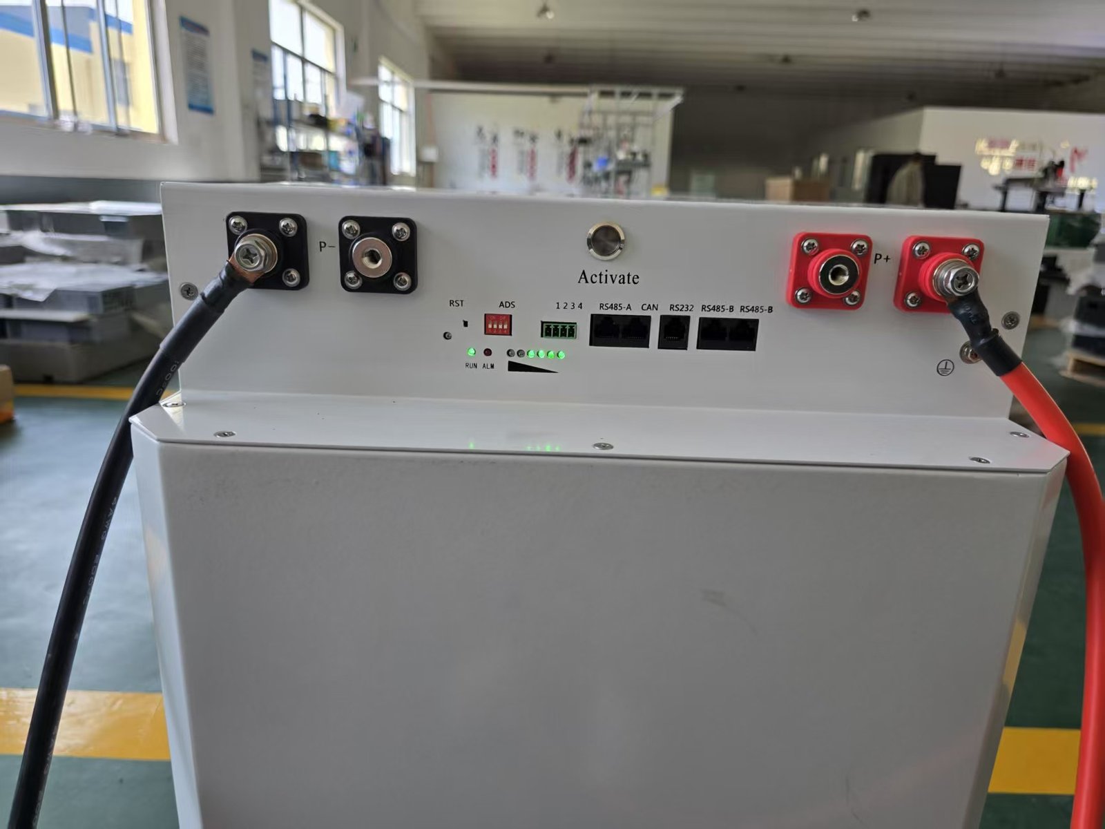 A green rugged case with black latches on a white background